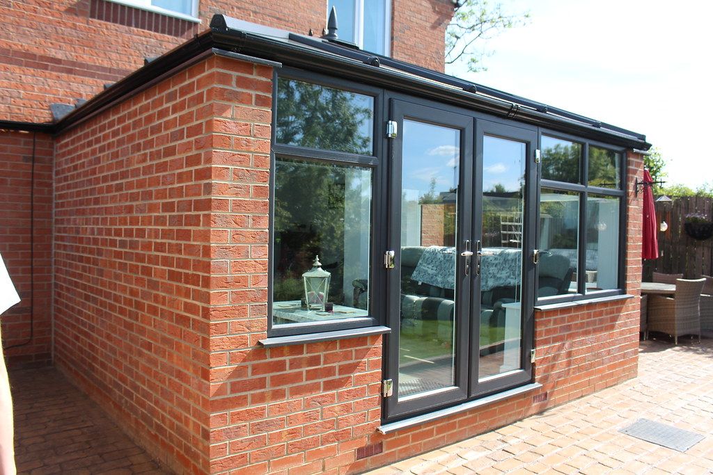 After: the same conservatory with a new grey tiled warm roof