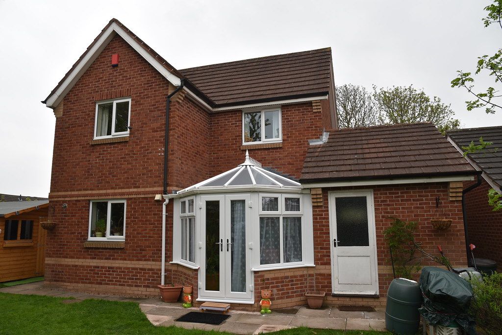Before: a conservatory with an old glass roof