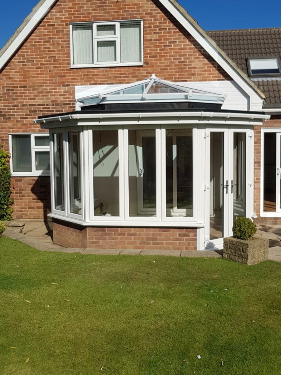 White Victorian conservatory on a gable fronted house