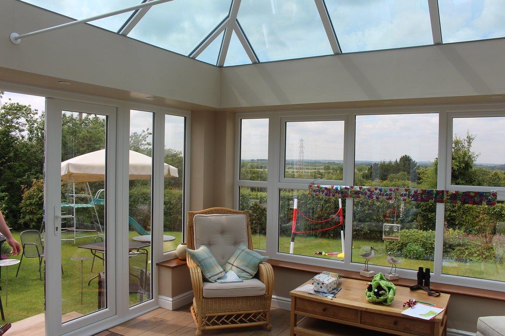 Bright conservatory interior with a sofa and plants