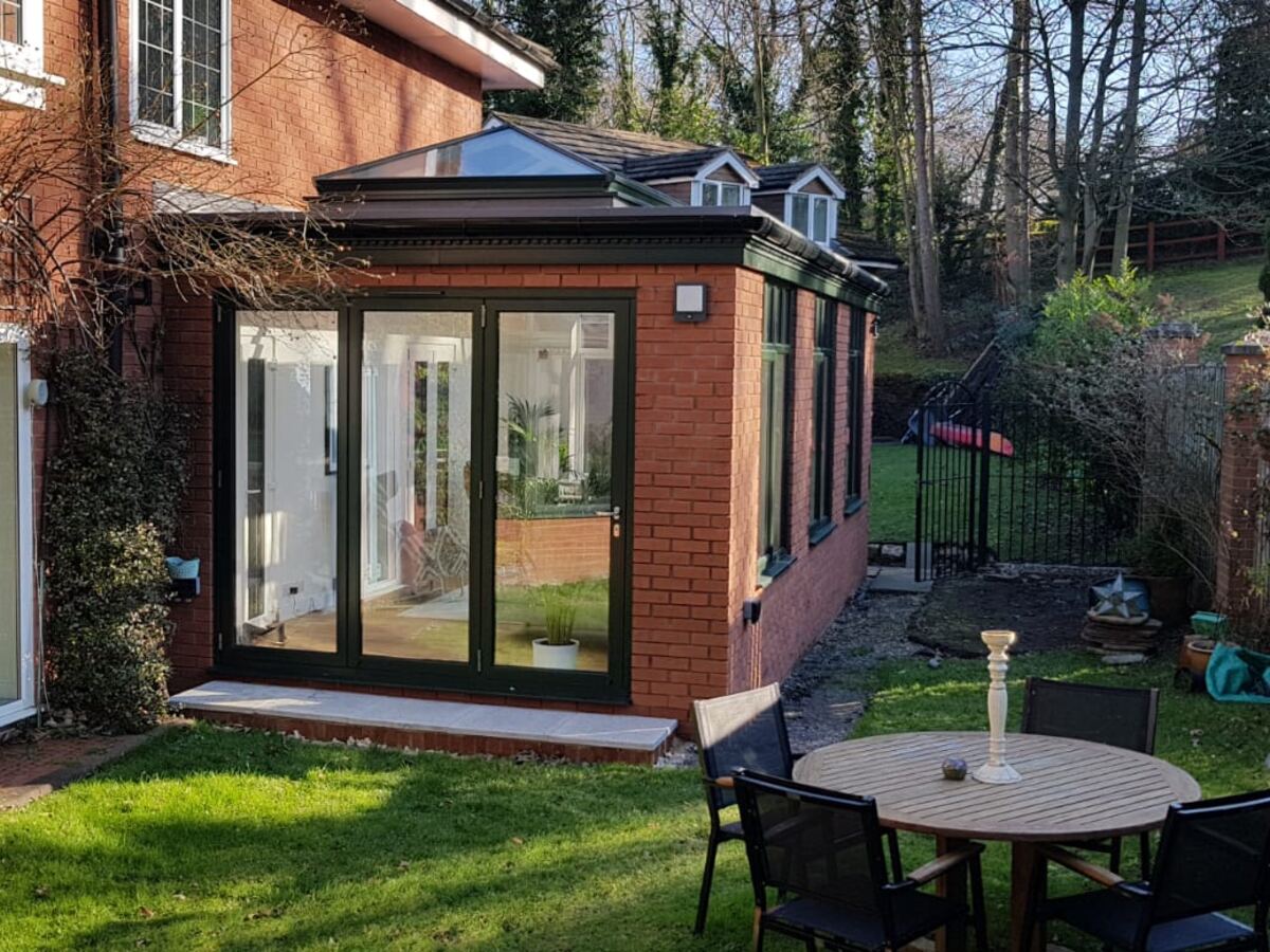 An orangery with solid pillars and a glazed lantern roof